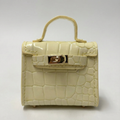 Beige crocodile-patterned handbag with a gold clasp on a white background