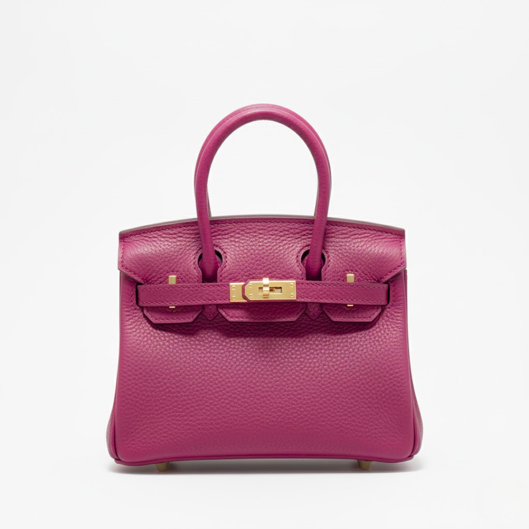 Pink handbag with gold hardware on a white background