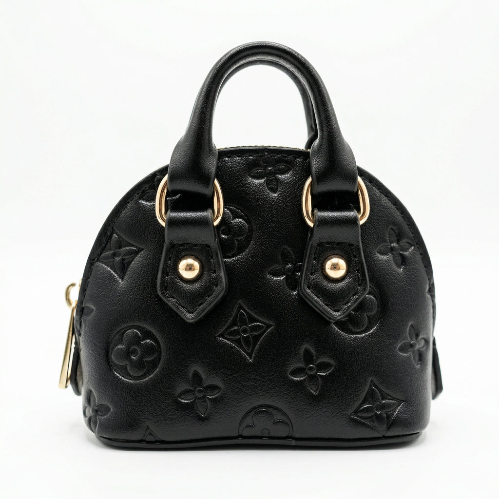 Black handbag with gold hardware on a white background