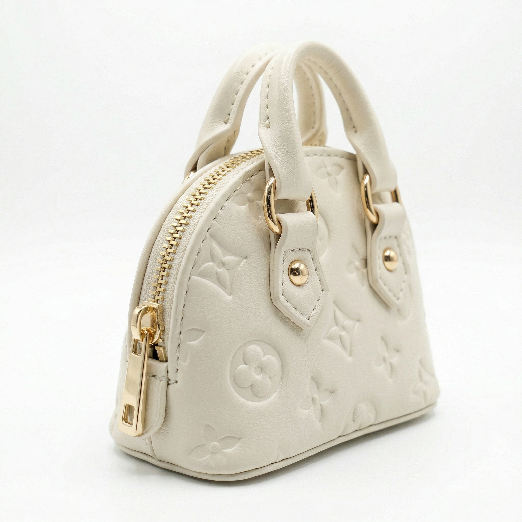 White handbag with gold accents on a white background