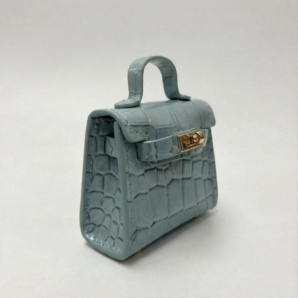 Light blue handbag with gold clasp on a white background