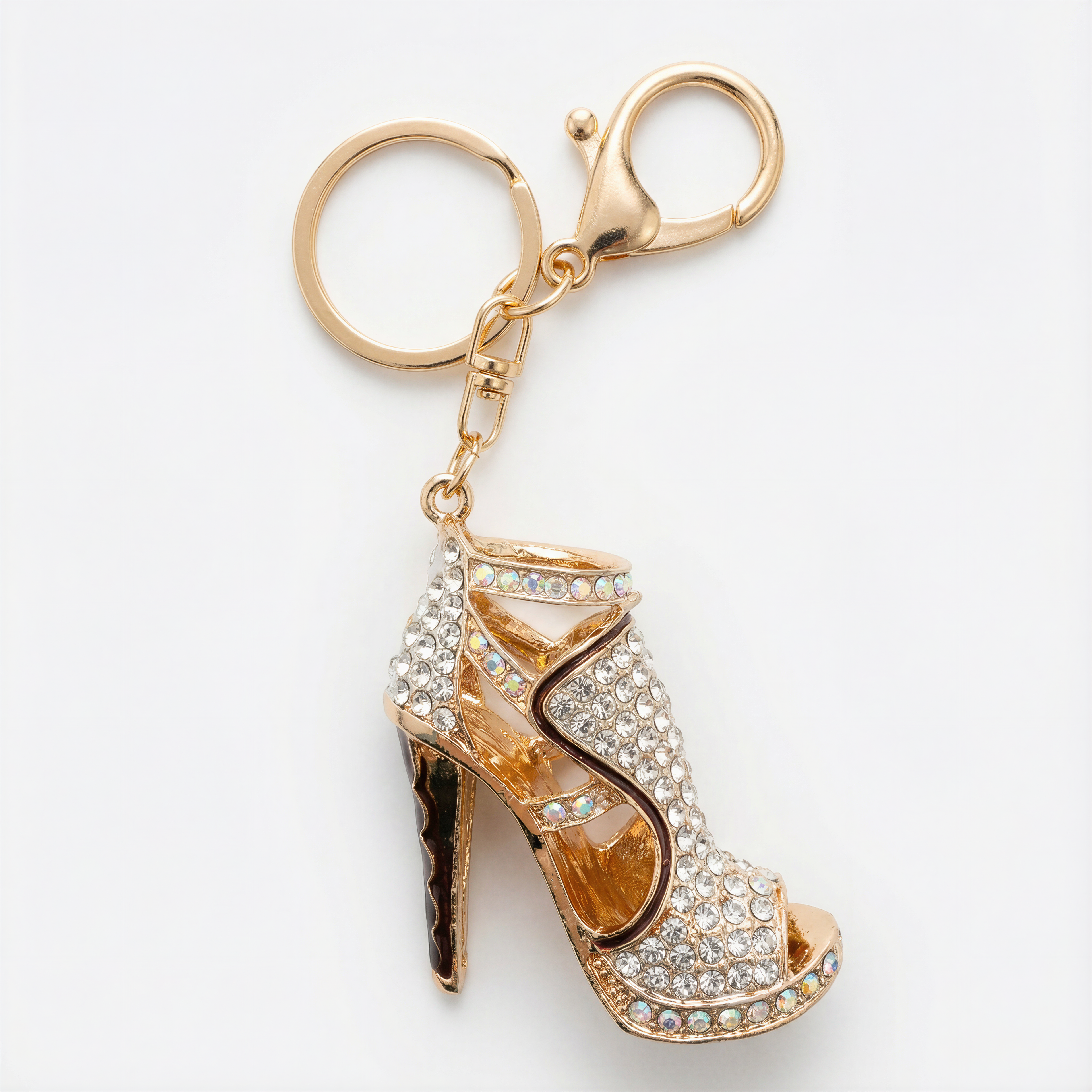 Gold high-heeled shoe keychain with rhinestones on a white background